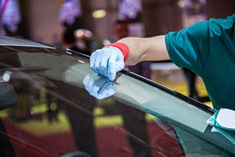 Burlington Krown crew tinting a car glass